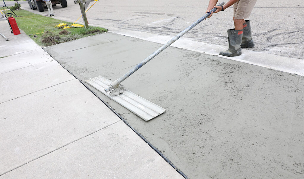 Concrete leveling being performed on sideway area of urban neighborhood in Denver, CO.